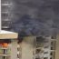 Noida apartment fire with smoke billowing from windows